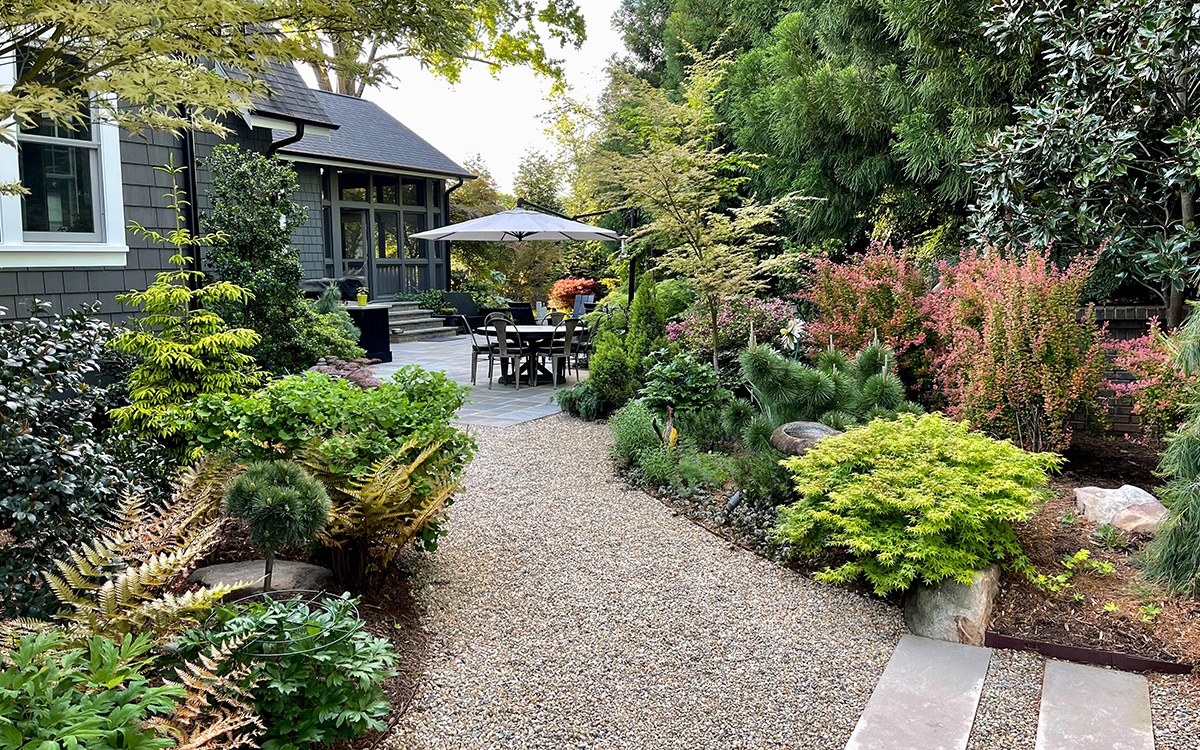gravel path leading to patio and gardens
